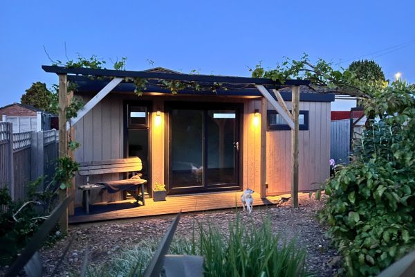 garden studio at night with lights on 